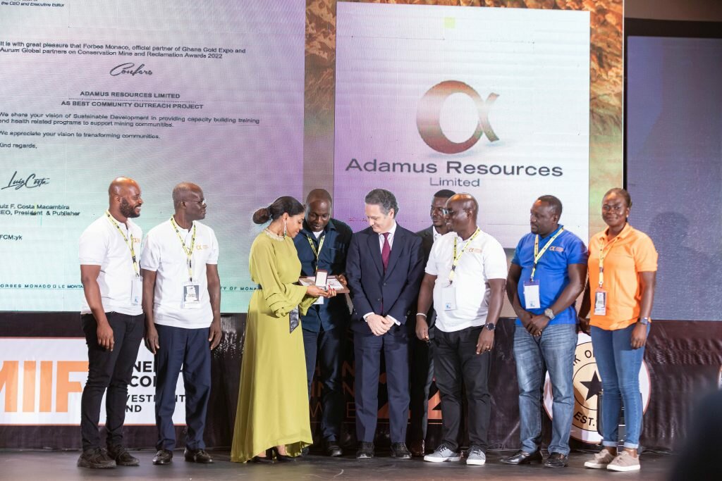 Ms Angela List and other representatives from the Adamus Resources receive award on behalf of the company..